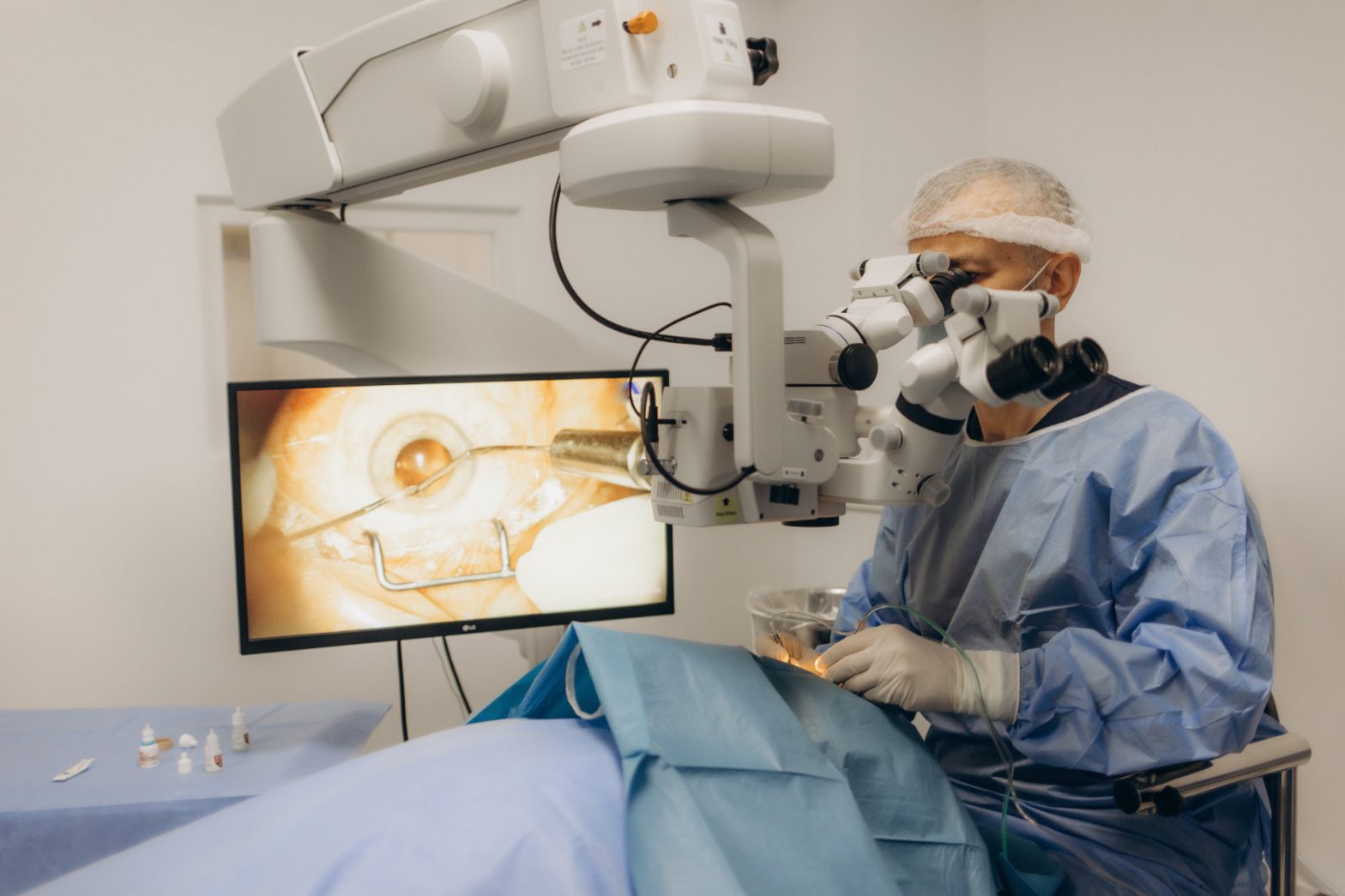 A surgeon looks through a microscope in the operating room. A doctor uses a microscope during eye surgery or diagnosis, cataract treatment and diopter correction.